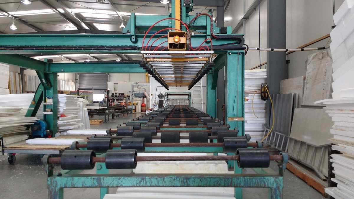 Usine industrielle avec machine de découpe et panneaux empilés